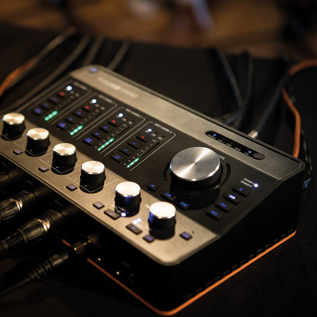 Angled view of Arturia AudioFuse Studio Audio Interface with cables attached on studio desk