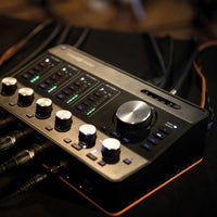 Angled view of Arturia AudioFuse Studio Audio Interface with cables attached on studio desk