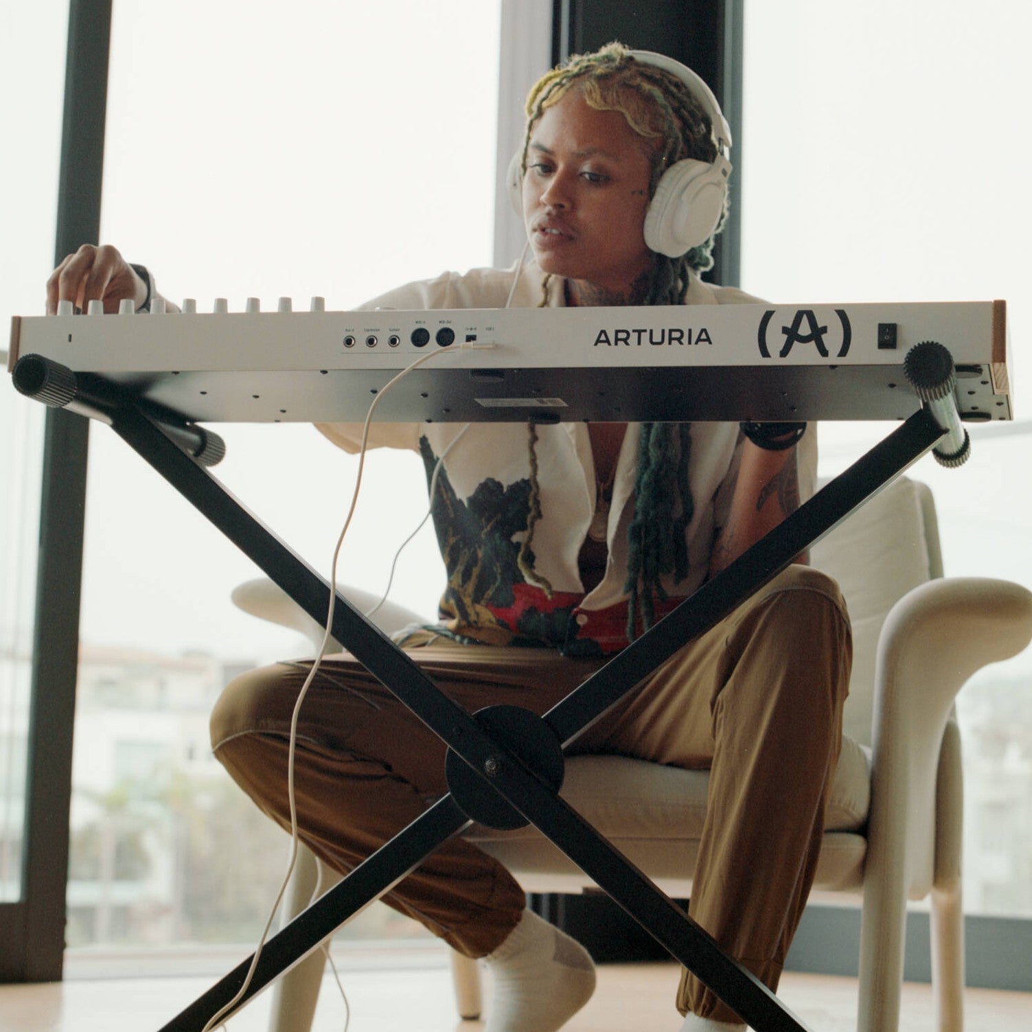 Musician playing the Arturia KeyLab 49 mk3 MIDI Controller White in studio