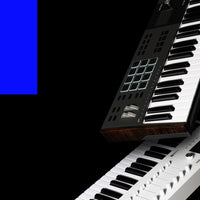 Floating angled view of Arturia KeyLab 61 mk3 MIDI Controller Black and White on black background with blue rectangle accent on the side