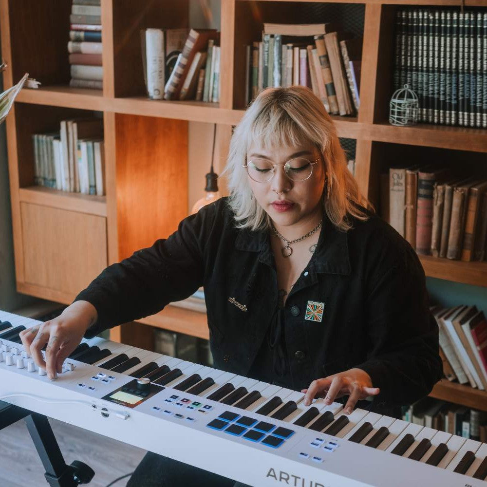 Pianist playing with of Arturia KeyLab 88 mk3 MIDI Controller White in home studio