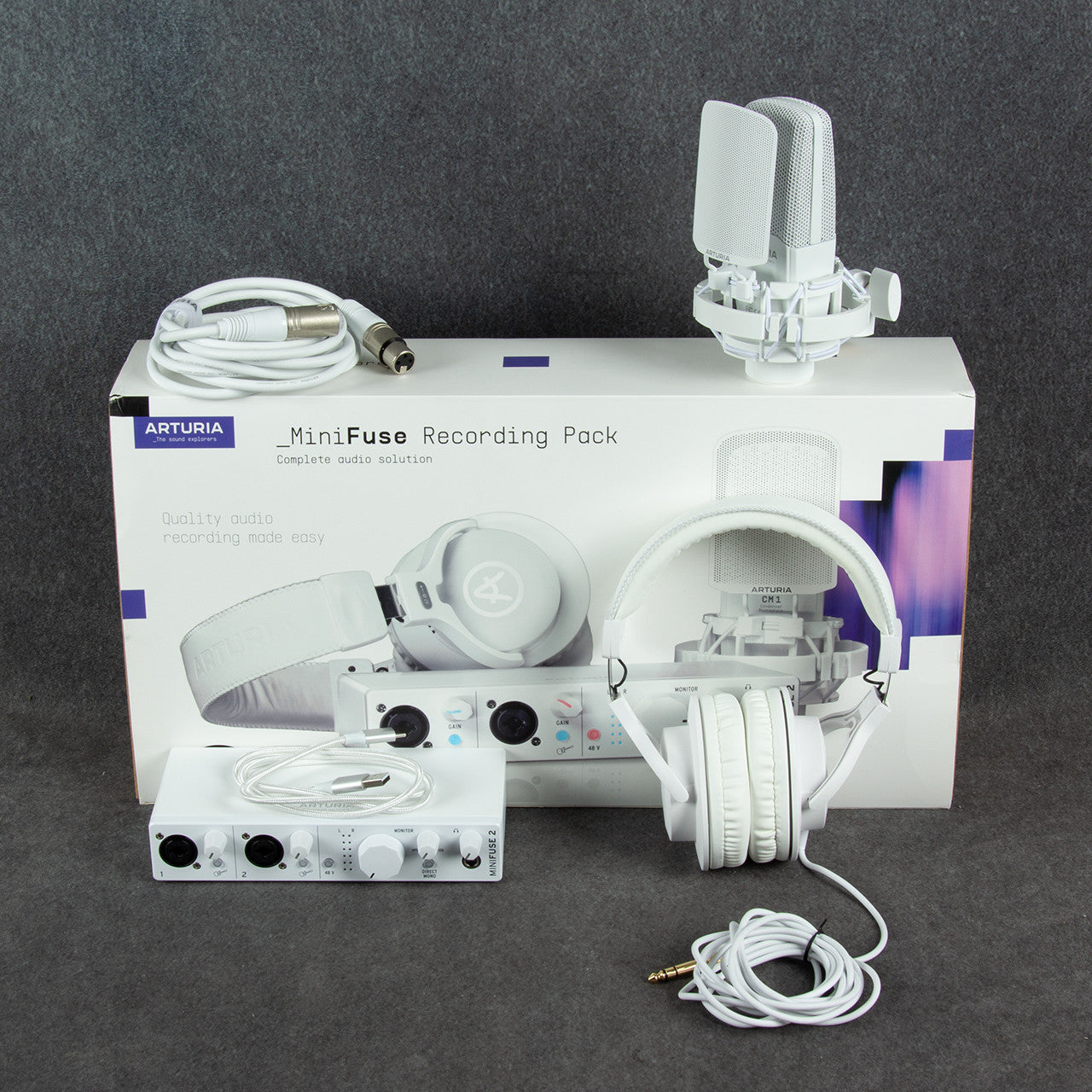 Inclusions of Arturia MiniFuse Recording Pack White on top of box on gray surface