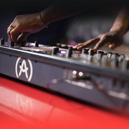 Angled rear view of Arturia PolyBrute Analog Matrix Synthesizer with musician playing it in studio