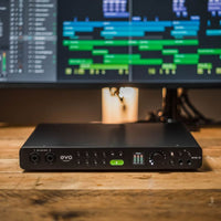 Front view of Audient EVO 16 on wooden surface with monitor in the background in studio