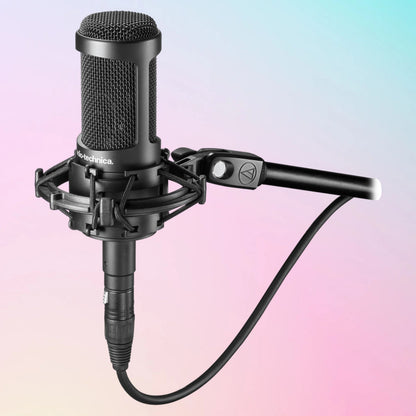 Mounted Audio-Technica AT2050 Multi-pattern Condenser Microphone on mic stand on pink and blue gradient background