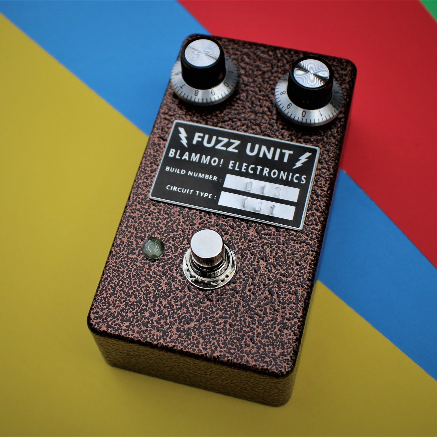 Angled front view of BLAMMO! Electronics P2P Tone Bender MKi Pedal on multi-colored background