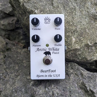 Front view of BearFoot FX Arctic White Fuzz pedal on rocks