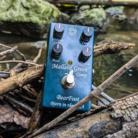 Front view of BearFoot FX Mallard Green Compressor on woods by the river with rocks in the background