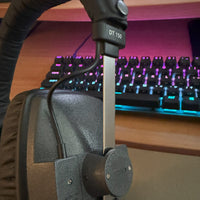 Close up view of Beyerdynamic DT 150 Closed-Back Monitor Headphones with keyboard in the background in studio