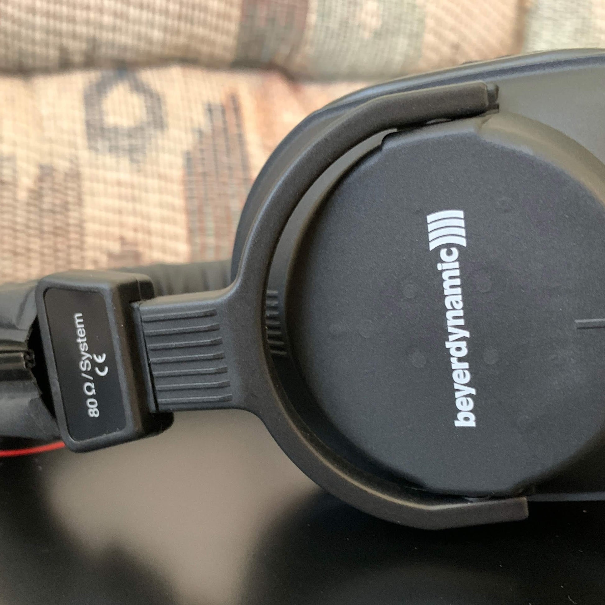 Close up view of Beyerdynamic DT 250 Closed-Back Headphones (80 Ohms) on table with couch in background