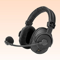 Black headset with microphone on a beige background