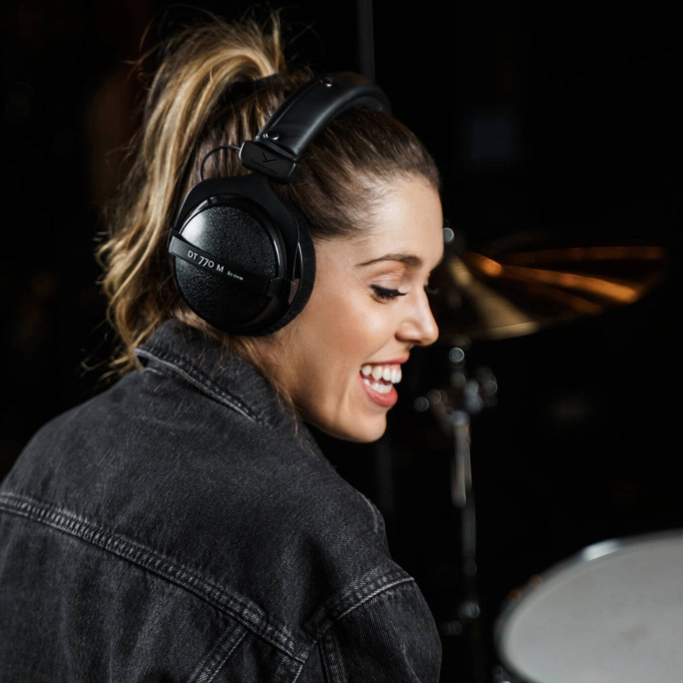 Musician wearing the Beyerdynamic DT 770 M Over-Ear Closed-Back Headphones (80 Ohms) in studio