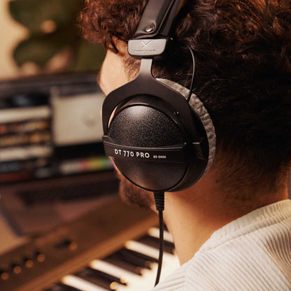 Studio engineer wearing Beyerdynamic DT 770 PRO Over-Ear Closed-Back Reference Headphones 80 Ohms in studio