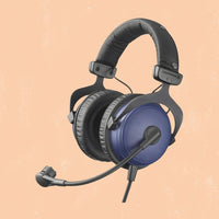 Black and blue gaming headset on a beige background