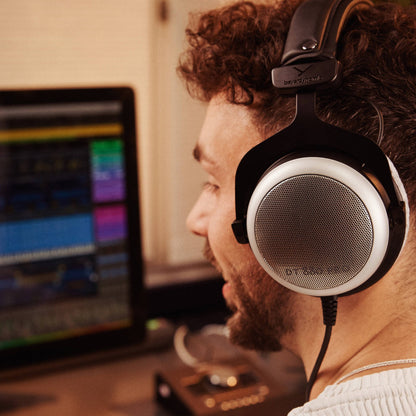 Studio engineer wearing the Beyerdynamic DT 880 PRO Semi-Open Studio Headphones in studio