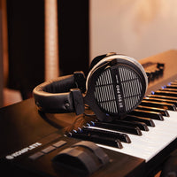 Beyerdynamic DT 990 PRO Over-Ear Open-Back Studio Headphones on top of keyboard in studio