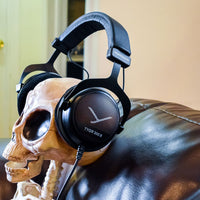Beyerdynamic TYGR 300 R Open Gaming Headphones on skull of skeleton mannequin on couch