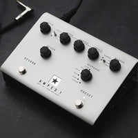 Angled top view of Blackstar AMPED 1 100W Guitar Amplifier Pedal on with cables around on dark surface