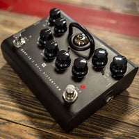 Angled view of Blackstar Dept. 10 Dual Distortion Pedal on wooden surface with red accent