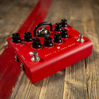 Angled view of Blackstar Dept. 10 Dual Drive Pedal on wooden surface with red accent