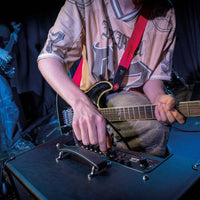 Close up angled view of Blackstar ID:X 50 Combo Amplifier on stage with guitarist tweaking its knobs