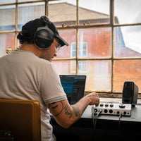 Front view of Blackstar POLAR 4 Audio Interface on desk with sound engineer tweaking its knob in studio