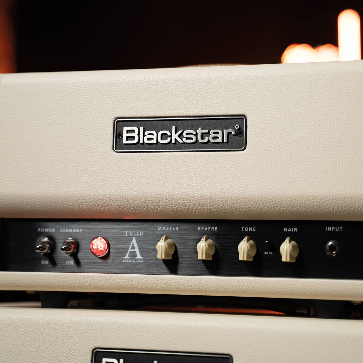 Close up front view of Blackstar TV-10 AH Guitar Amp Head on top of speaker cabinet in studio