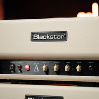 Close up front view of Blackstar TV-10 AH Guitar Amp Head on top of speaker cabinet in studio