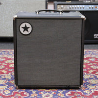 Front view of Blackstar Unity 120 120W Bass Combo Amplifier on paisley carpet with amplifiers in the background