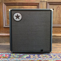 Front view of Blackstar Unity 60 60W Bass Combo Amplifier on colored carpet with wooden wall background