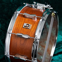 Upright side view of the Big Softy snare drum with velvet green background