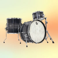 Angled view of British Drum Co. Legend Series 24" Rock Kit Carnaby Knight on yellow and orange background
