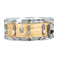 Snare drum with wooden shell and chrome hardware on a white background