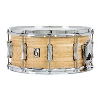 Snare drum with natural wood finish and chrome hardware on a white background