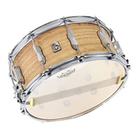 Snare drum with wooden shell and white head on a white background