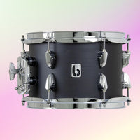 Front view of British Drum Co. Raven Rack Tom Drum on pink and yellow gradient background