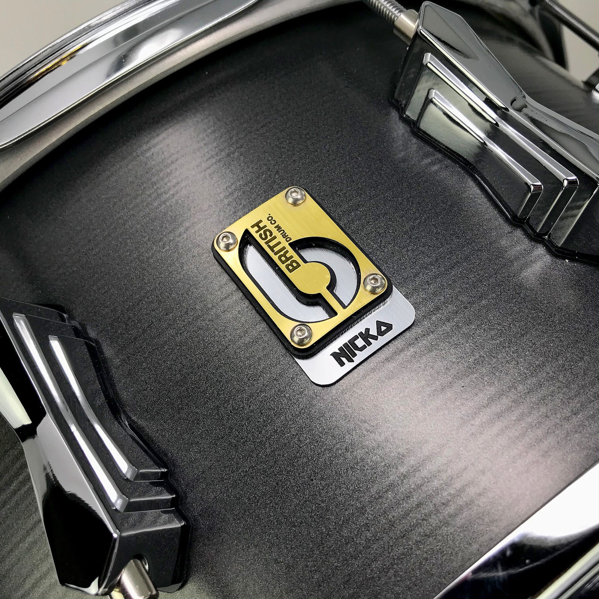 Close up view of British Drum Co. Talisman Nicko McBrain Signature Snare Drum on grey background