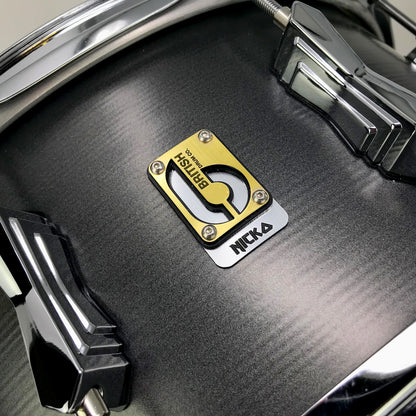 Close up view of British Drum Co. Talisman Nicko McBrain Signature Snare Drum on grey background