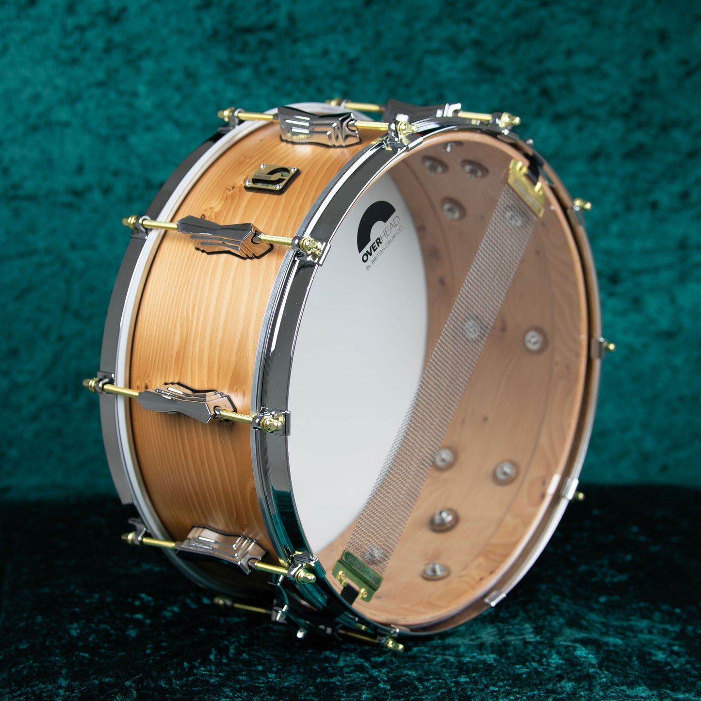 Angled view of British Drum Co. The Archer Snare Drum on green cloth background