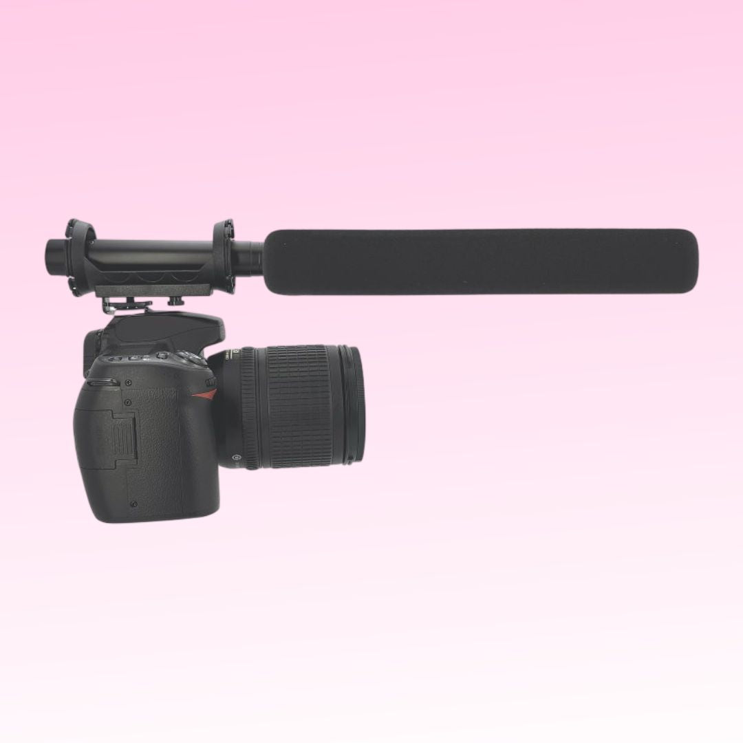 CAD Audio Astatic SM915B Battery-Powered Shotgun Microphone mounted on camera on pink background