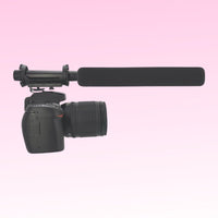 CAD Audio Astatic SM915B Battery-Powered Shotgun Microphone mounted on camera on pink background