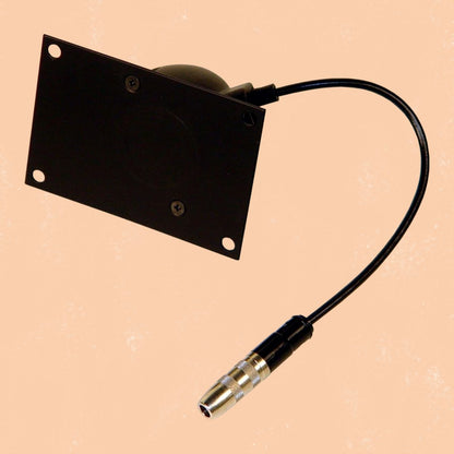 Angled view of CAD Audio WM-1000 Wall Dynamic Microphone on orange background
