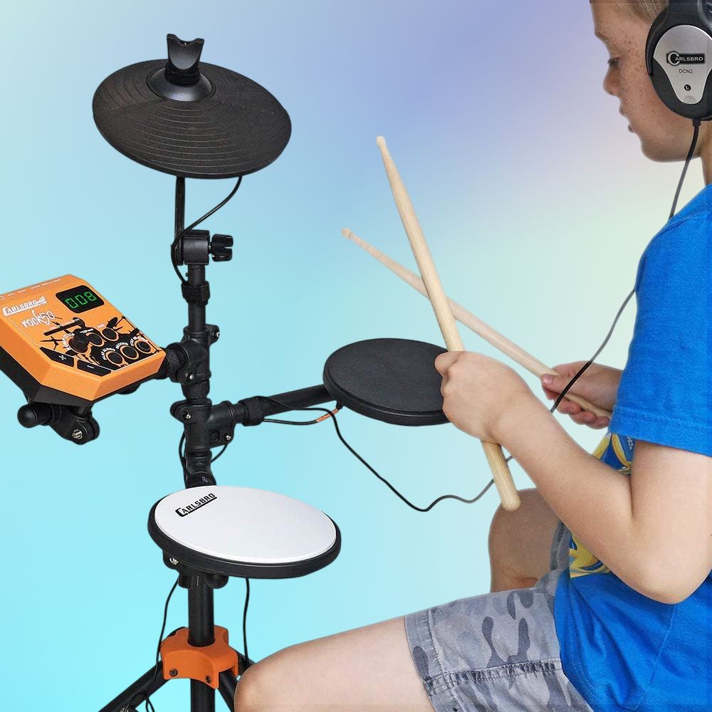 Child playing the Carlsbro ROCK 50 Junior Electronic Drum Kit on blue background