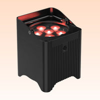 Black outdoor light fixture with red interior on a beige background