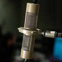 Coles 4050 Stereo on stand while angled with studio background