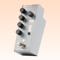 Angled view of Collision Devices Snack Delay Pedal on orange background
