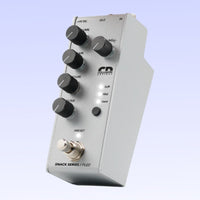 Angled view of Collision Devices Snack Fuzz Pedal on purple background