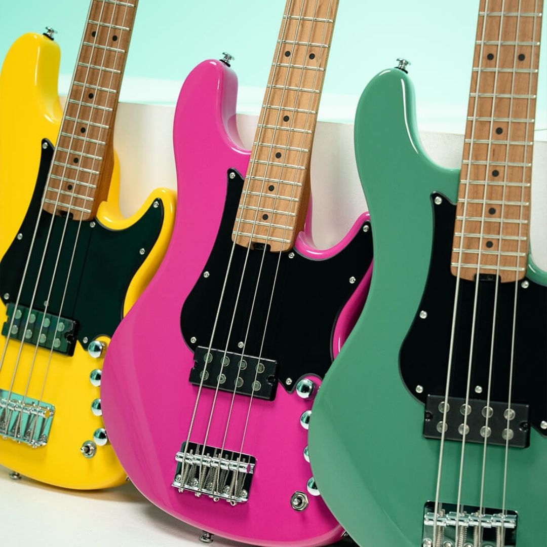 Side-by-side close up front view of Cort GB-Short Scale 4-String Electric Bass Guitar Yellow Crush, Forest Green, and Fandango Purple on white surface with blue background