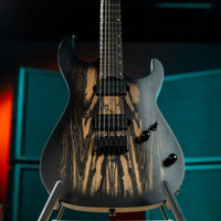 Close up front view of Cort KX500 Pale Moon Electric Guitar on stand with amplifiers in the background in studio
