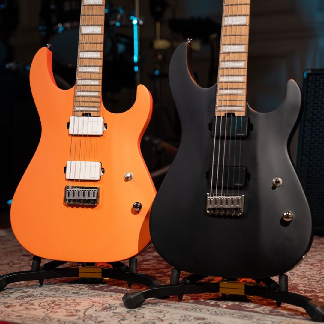 Close up view of Cort KX600 Infinite Electric Guitar Orange Crush Satin and Cort KX600 Infinite Electric Guitar Black Satin side by side in studio